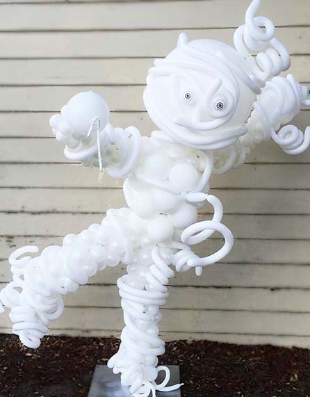 A five foot tall balloon mymmy sculpture dripping its mymmy wrapings all in ghostly white